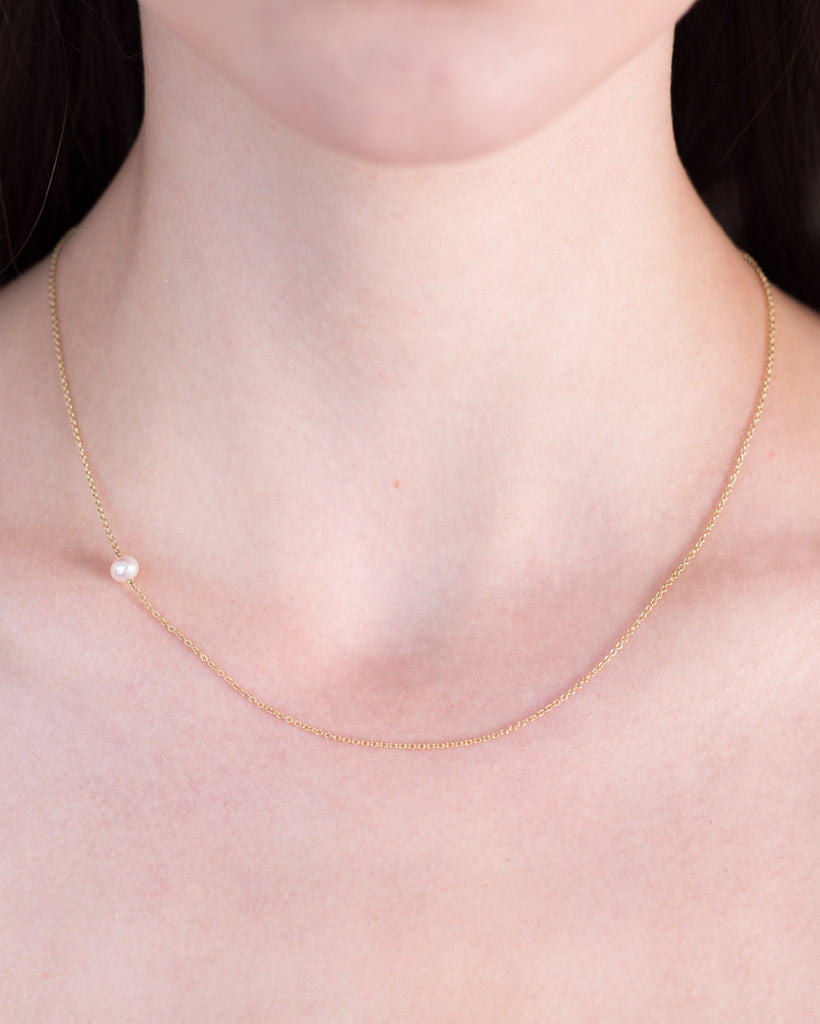 The Interval tiny pearl and gold necklace